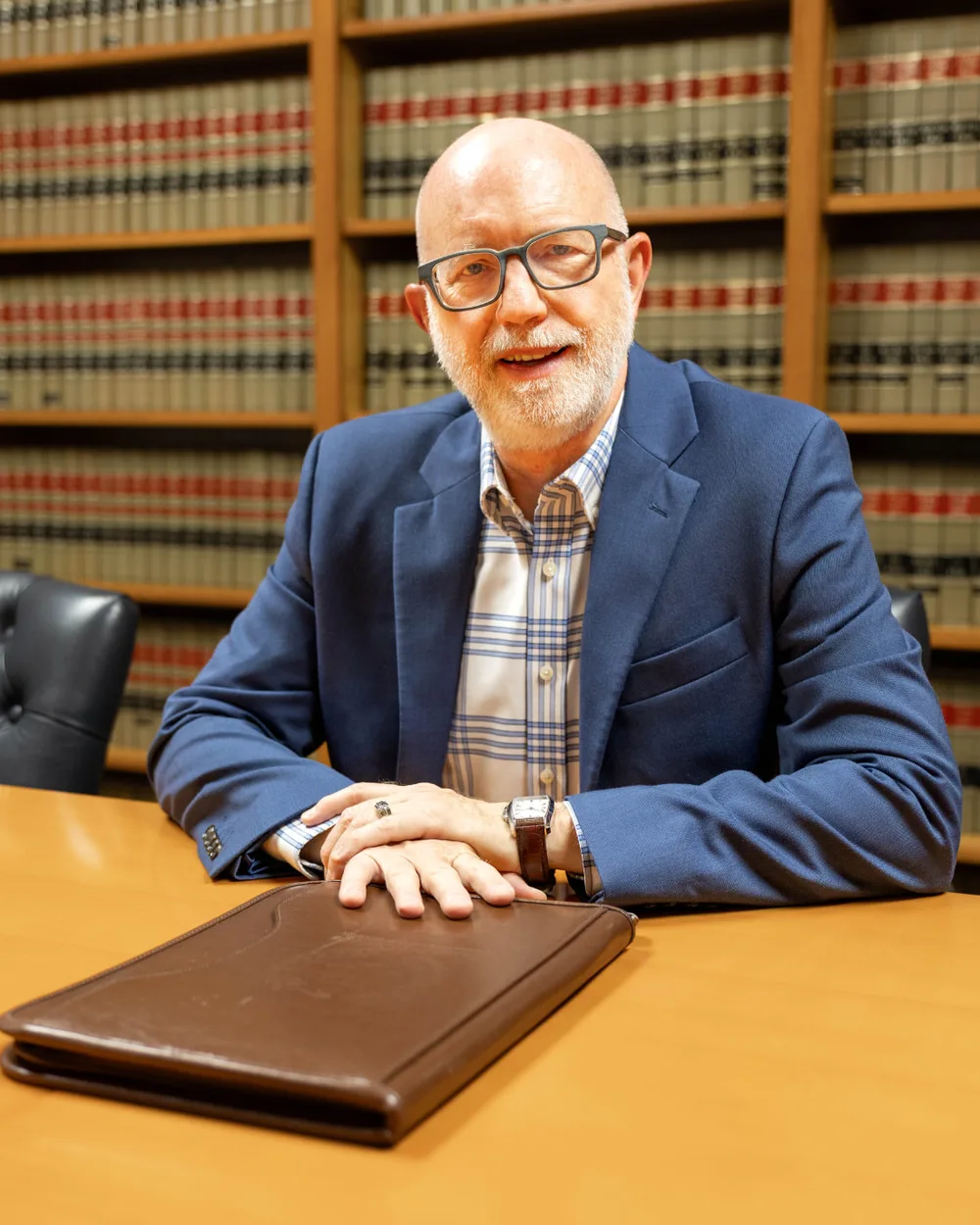 David M. Butterbaugh, San Antonio probate attorney, seated at a conference table in front of law books
