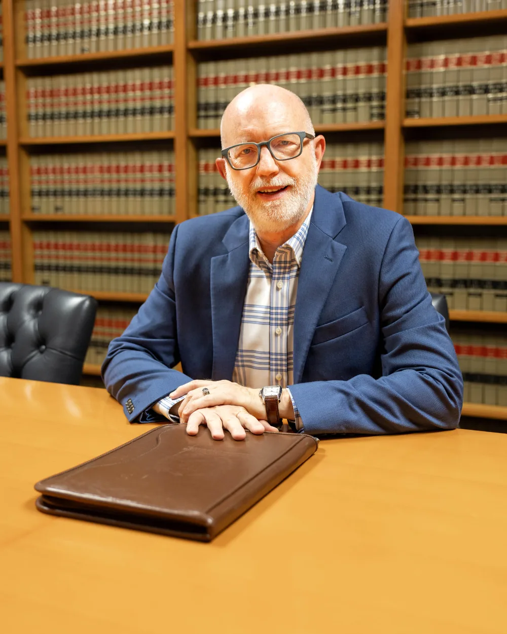 David M. Butterbaugh seated at a conference table in his San Antonio law library