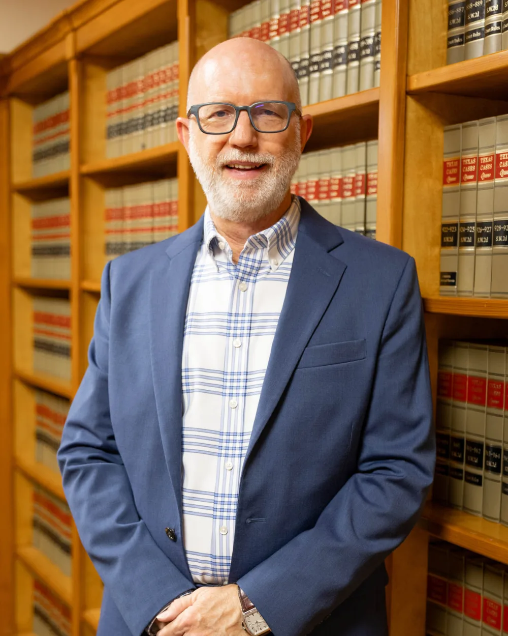 David M. Butterbaugh, San Antonio business attorney, standing in his law library